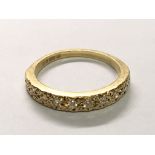 An 18carat yellow gold ring set with a row of ten diamonds. Ring size O-P