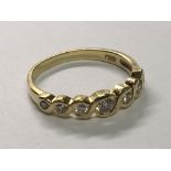 An 18carat yellow gold ring set with eight diamonds with a woven effect shank. Ring size L.