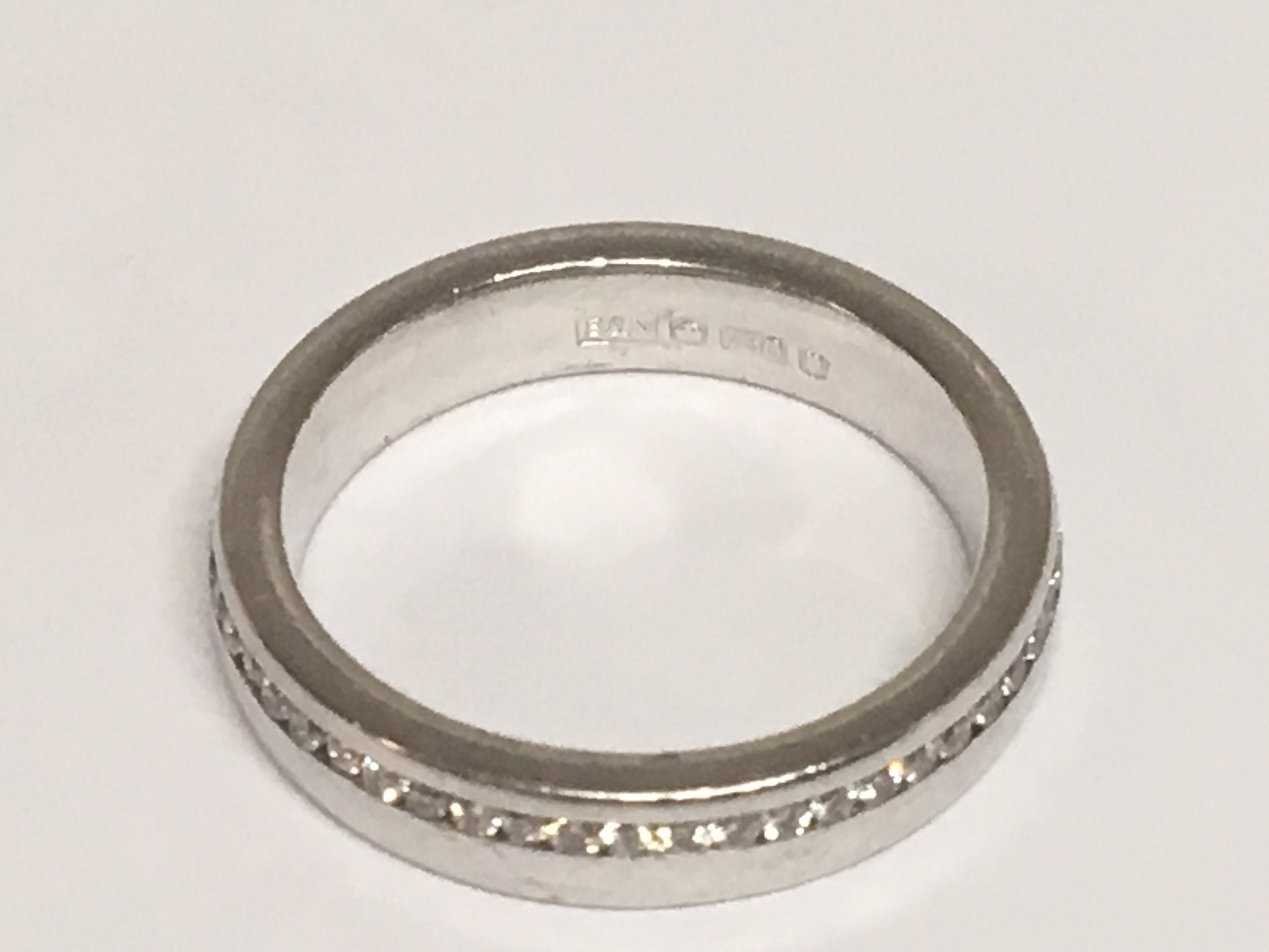 An 18carat white gold eternity ring set with a row of brilliant cut diamonds. ring size H.