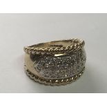 A 9carat gold diamond cluster ring with a rope twist edge. Ring Size N.