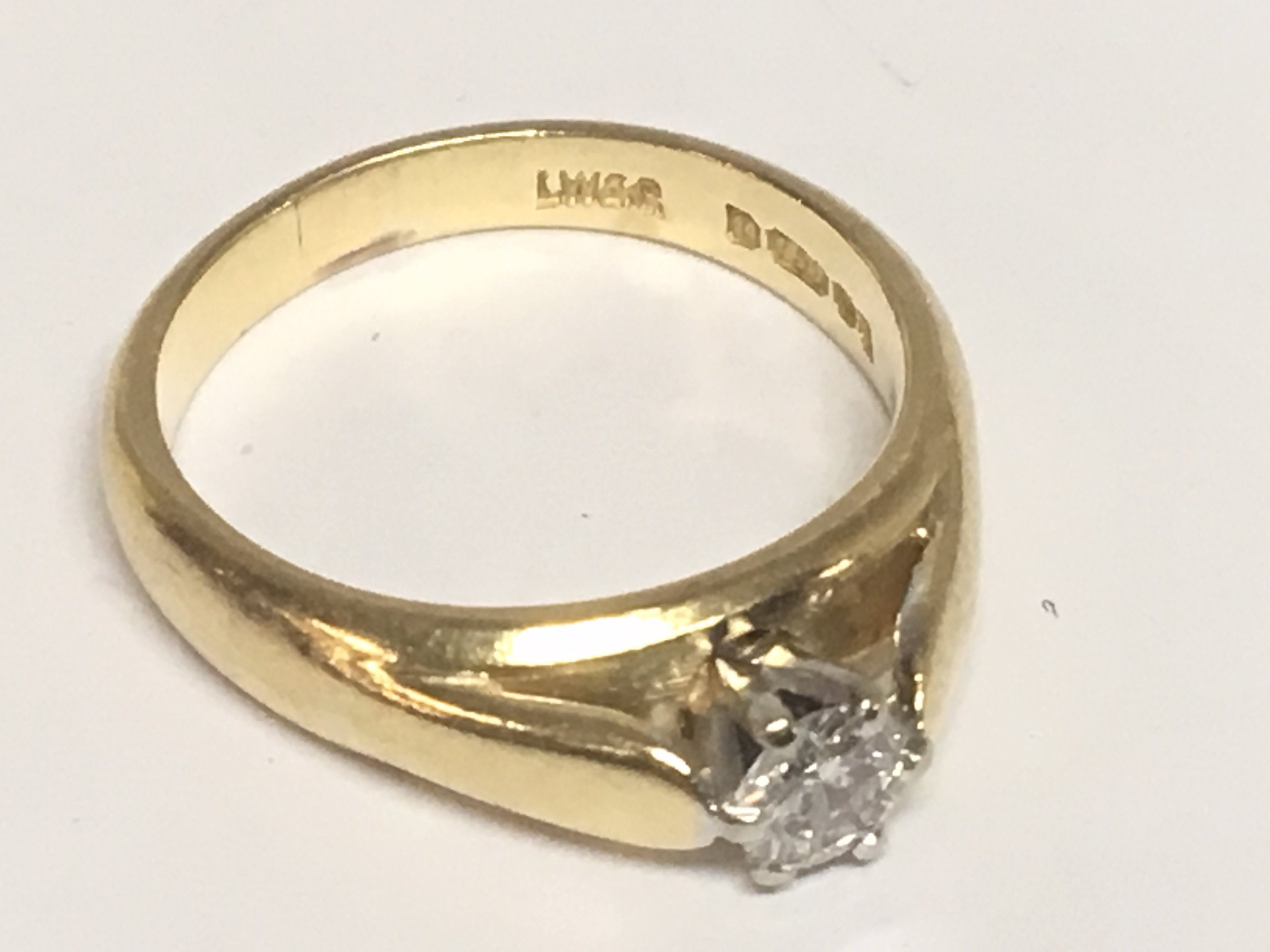 An 18carat gold ring set with a brilliant cut solitaire diamond approximately 0.25 of a carat.