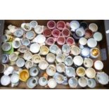 Approximately 60 novelty egg cups including retro, kitsch, Longton Pottery examples, Japanese etc