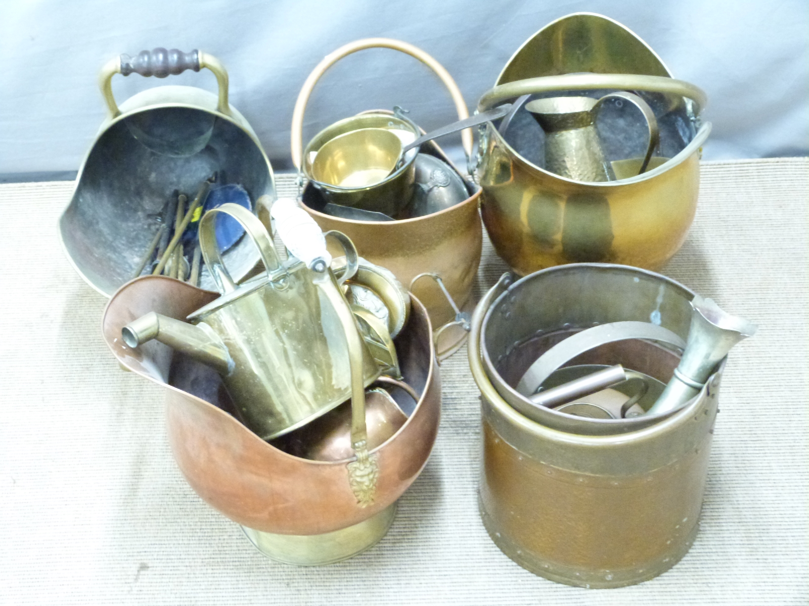 Five copper and brass coal scuttles, additional jam pans, watering can, kettle etc, tallest 53cm