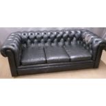 A black leather three seat Chesterfield sofa, W195cm