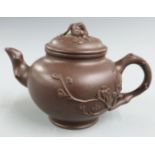 Chinese Yixing teapot with relief floral decoration and four character mark to base, 9.5cm tall