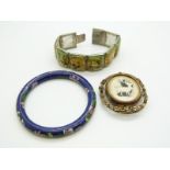 A white metal bracelet set with painted mother of pearl panels, a cloisonne bangle and a Victorian