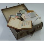 A suitcase of loose GB, Commonwealth and foreign stamps and a Lincoln stamp album