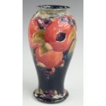 Moorcroft pedestal vase decorated in the Pomegranate pattern including two open pomegranates on a