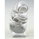 Inuit stone carving of a woman carrying a sack, 17.5cm tall