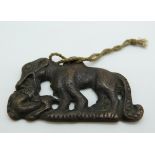 Japanese bronze pendant depicting animals, 6 x 4.2cm