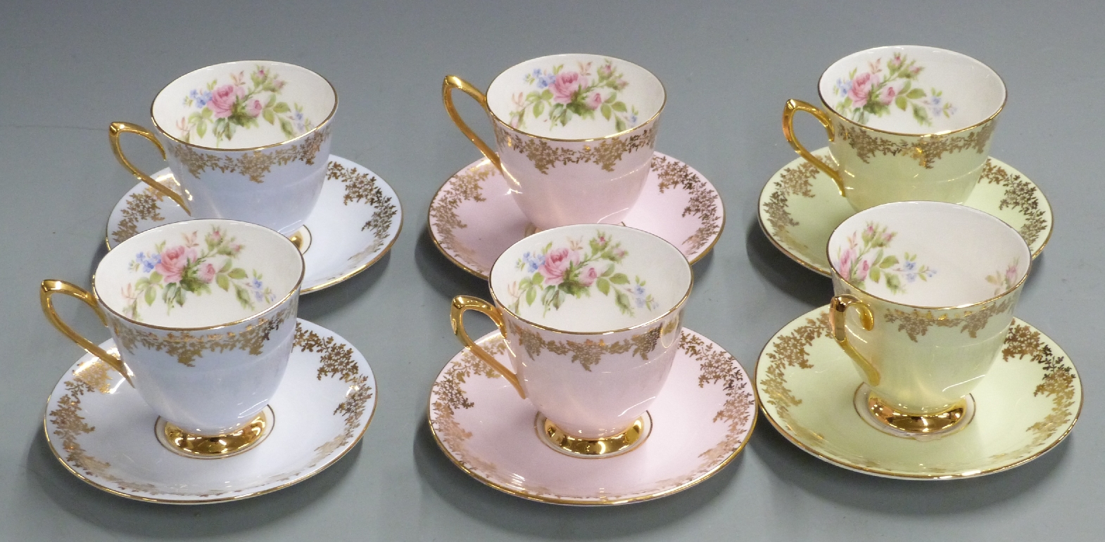 Six Royal Albert cups and saucers with gilded exterior and florally decorated interior