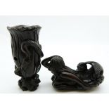 Japanese dark wood netsuke depicting a small frog carrying a tree trunk with another frog on the