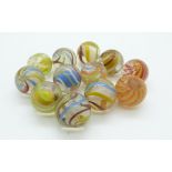 Twelve various glass marbles all with multicolored twist decoration, largest 21mm in diameter