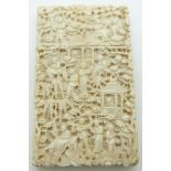 A 19thC Chinese carved ivory card case decorated with court / village scenes, 9.5 x 6cm