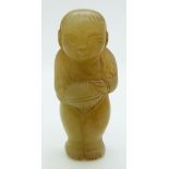 A 19thC Chinese jade toggle depicting a boy holding an object, H5.5cm