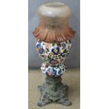 An earthenware oil lamp with frilled glass shade, H 62cm