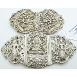 Two white metal buckles in the form of deities