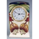 Moorcroft clock decorated in the Anna Lily pattern, H16cm, with box