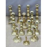 Six pairs of brass candlesticks and two odd examples, tallest pair 26cm