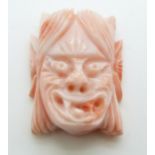 Chinese carved coral mask of a female demon, 3cm.