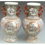 A pair of Chinese twin handled famille rose vases decorated with court scenes and bats, six