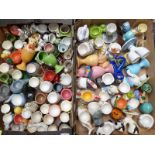 Approximately 100 mostly ceramic egg cups including VW Camper, animals, Devon pottery, Honiton, Toby