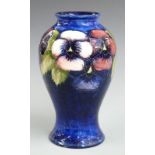 Moorcroft pedestal vase decorated in the Pansy pattern on a blue ground, signature and impressed '