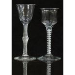 Two 18thC drinking glasses, one with air twist stem and round funnel shaped bowl raised on a conical