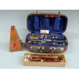 A cased Lark clarinet, together with a Dolmetsch treble recorder and a French-made metronome