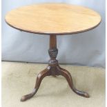 A 19thC mahogany tilt top table raised on a turned support and tripod base, the top a single piece