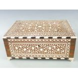 A 19thC/20thC Indian inlaid bone Vizagapatam dressing table box with fitted interior, raised on