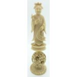 A 19thC carved Chinese ivory chess piece with puzzle ball, 13.5cm