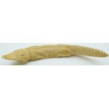 An early 20thC ivory crocodile, 21cm