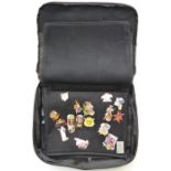 A collection of Hard Rock Café pin badges in a branded carry case