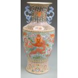 A large Chinese twin handled famille rose vase decorated with dragons, with six character mark to