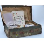 A suitcase of all-world stamps, loose and on sheets