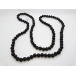 A Chinese necklace made up of caved lacquer prayer beads