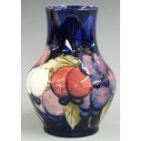 Moorcroft pedestal vase decorated in the Wisteria pattern on a blue ground, impressed and