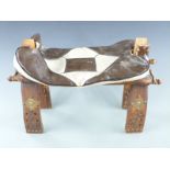 An Eastern camel seat or stool with brass studded decoration to the legs and leather cushion, 60cm