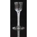 An 18thC drinking glass with white double twist stem and ogee shaped bowl raised on conical foot,