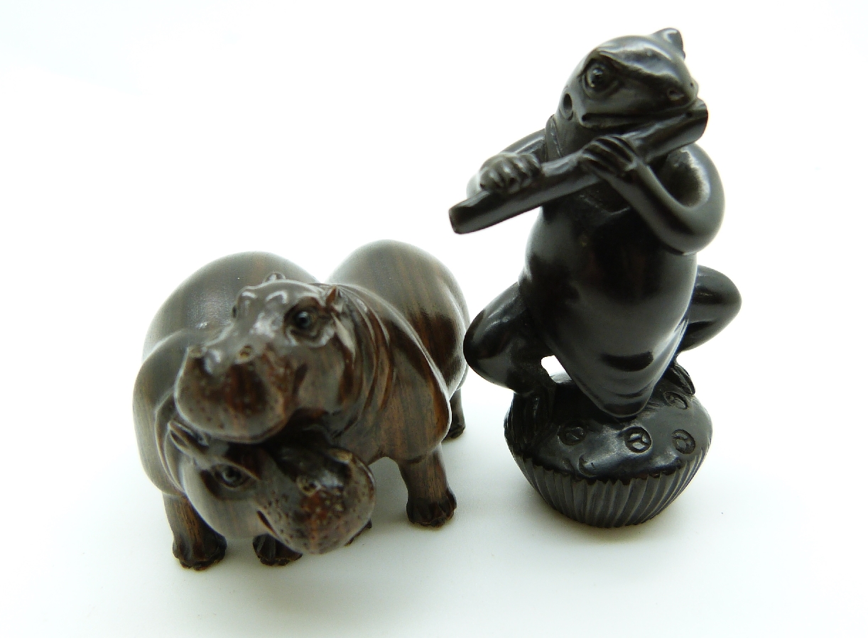 Japanese dark wood netsuke depicting a frog playing a musical instrument together with a Japanese