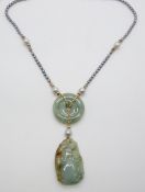 A pearl necklace strung with a jadeite disc, a carved jadeite pendant and gold beads with 9ct gold