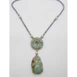 A pearl necklace strung with a jadeite disc, a carved jadeite pendant and gold beads with 9ct gold