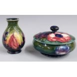 Moorcroft pedestal covered bowl in Anenome pattern and a pedestal vase in the Leaf and Berry