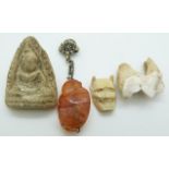 Chinese agate carving of a monkey, an ivory netsuke of a man/devil and a stone carving of Guanyin