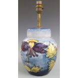 Moorcroft table lamp decorated in the Orchid pattern on a pale blue ground, H34cm