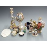 A collection of continental and majolica ceramics including a Dresden pedestal covered cup, figures,