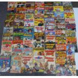 Sixty-four vintage cowboy and Western comics including Tim Tyler Cowboy, Wyatt Earp, Fighting