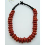 A Tibetan faux coral glass necklace