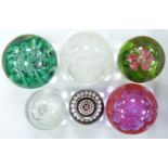 Five Caithness glass paperweights comprising Seaform, Miniature Rose, Celebration, Silver Jubilee